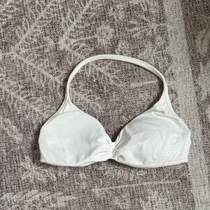 White DFYNE halter sports bra. Light pink stain on the inside of straps